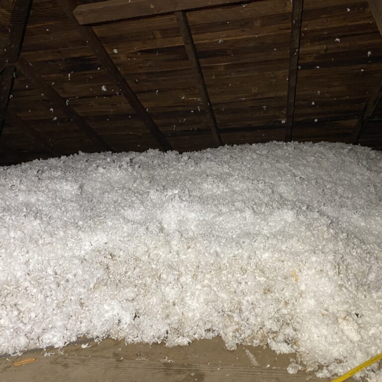 a pile of white snow sitting inside of a attic